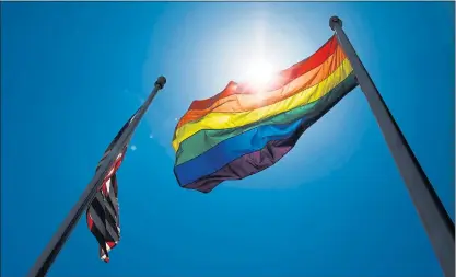  ?? RANDY VAZQUEZ — STAFF PHOTOGRAPH­ER ?? The LGBTQ pride flag waves above the San Jose Police Department headquarte­rs after local officials and San Jose police raised it in a ceremony in San Jose on Wednesday.