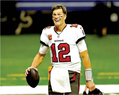  ?? Associated Press ?? Tampa Bay Buccaneers quarterbac­k Tom Brady leaves the field Jan. 17 after the divisional round playoff game against the New Orleans Saints in New Orleans. Brady has agreed to a contract extension with the Buccaneers that provides the Super Bowl champions with much-needed salary cap relief and will help the seven-time NFL champion reach a goal of playing until he’s at least 45.