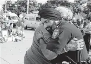  ?? Jon Shapley / Staff file photo ?? Harris County Sheriff ’s Deputy Sandeep Dhaliwal gets a hug at a memorial in 2015 for Deputy Darren Goforth. Dhaliwal was the department’s first Sikh deputy.