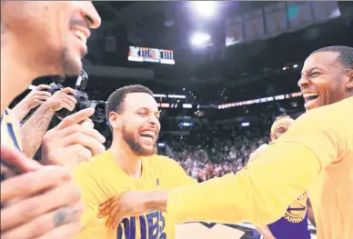  ?? RONALD MARTINEZ / AFP ?? Stephen Curry (left) celebrates with Andre Iguodala after leading the Golden State Warriors to Monday’s 129-115 victory over the San Antonio Spurs and a sweep of their NBA Western Conference final at AT&T Center in San Antonio, Texas.