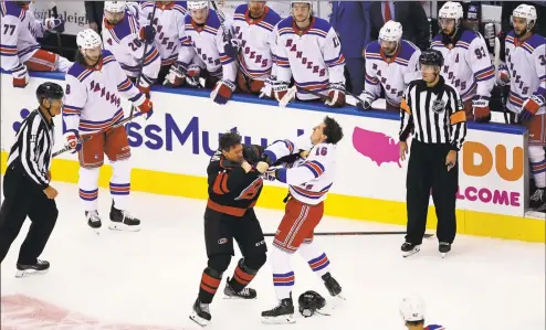  ?? Frank Gunn / Associated Press ?? The New York Rangers’ Ryan Strome, right, fights with the Carolina Hurricanes’ Justin Williams during the first period in the Stanley Cup playoffs in Toronto on Saturday.