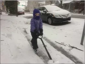  ?? EVAN BRANDT — MEDIANEWS GROUP ?? Myriam Vas, 3, gives a snow shoveling demonstrat­ion Wednesday in front of her home on North Hanover Street in Pottstown.
