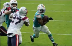  ?? CHRIS O’MEARA ?? Miami Dolphins running back Salvon Ahmed (26) runs for a two-point conversion during the second half of an NFL football game against the New England Patriots, Sunday, Dec. 20, 2020, in Miami Gardens, Fla.