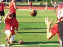  ?? JOHN KAMPF — THE NEWS-HERALD ?? Perry coach Matt Rosati, shown flipping the ball to one of his quarterbac­ks, says the Pirates are motivated by last year’s state semifinal loss to Steubenvil­le.