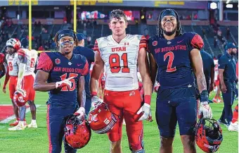  ?? ICON SPORTSWIRE/VIA AP IMAGES ?? New Mexico True: From left, Manzano alumnus Jordan Byrd, La Cueva alum Connor O’Toole and Rio Rancho alum Keshawn Banks pose after the San Diego State-Utah Game in September in Los Angeles.