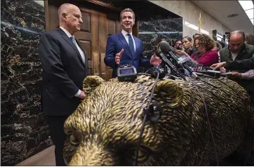  ?? PAUL KITIGAKI JR. — SACRAMENTO BEE ?? Gov. Jerry Brown and Lt. Gov. Gavin Newsom, who will be sworn in as California’s next governor on Jan. 7, speak to the media outside the governor’s office at the state capitol in Sacramento this month.