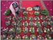  ?? SAKCHAI LALIT / AP ?? A devotee prepares fruits and flower offerings to Hindu Goddess Lakshmi during Diwali at Vishnu temple in Bangkok, Thailand, Thursday.