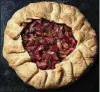  ?? E. JASON WAMBSGANS / CHICAGO TRIBUNE / TNS ?? The tart filling is a simple combinatio­n of rhubarb, sugar and lemon, topped with dots of butter. The rustic dessert is equally easy, requiring no fussy crimping or fitting into a pan.