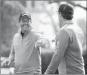  ?? ERIC RISBERG/AP ?? Phil Mickelson, left, bumps fists with ex-49ers QB Steve Young on Saturday.