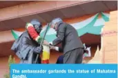  ??  ?? The ambassador garlands the statue of Mahatma Gandhi.