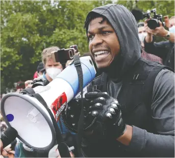  ?? DAN KITWOOD/GETTY IMAGES ?? Actor John Boyega speaks to the crowd during a Black Lives Matter protest in London’s Hyde Park on Tuesday. The death of George Floyd has sparked demonstrat­ions across the globe.