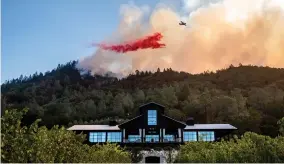  ?? AP PHOTO BY NOAH BERGER ?? An air tanker drops retardant on the Glass Fire burning above Davis Estates winery in Calistoga, Calif., on Sunday, Sept. 27, 2020.