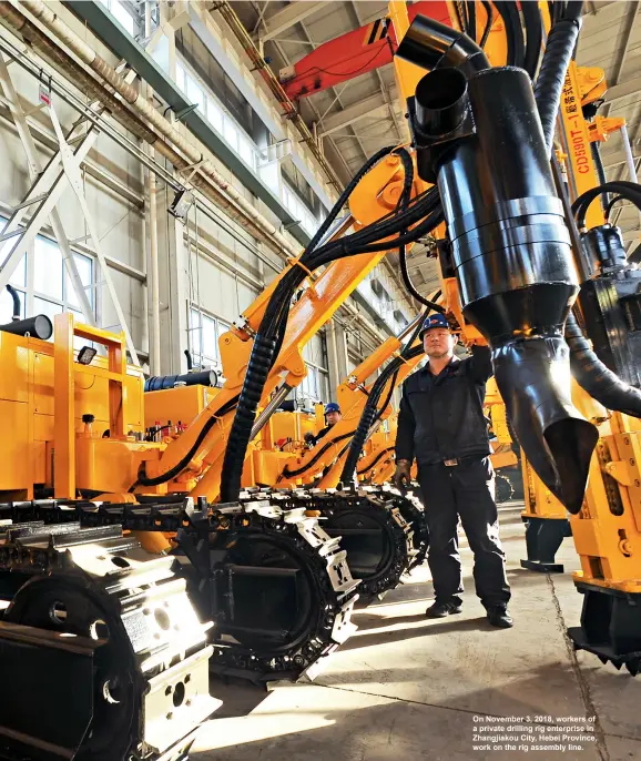  ??  ?? On November 3, 2018, workers of a private drilling rig enterprise in Zhangjiako­u City, Hebei Province, work on the rig assembly line.