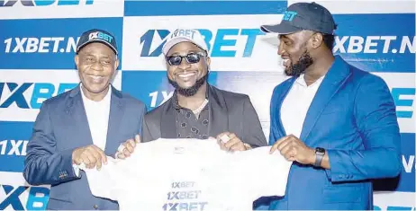  ?? Ewuzie Chigozie, business developmen­t, ?? L-R: Oluwafemi Babalola, managing director, 1xbet Nigeria; David Adeleke (Davido), and 1xbet Nigeria, at the unveiling of Davido as brand ambassador of the company in Lagos.