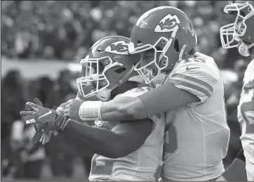  ?? The Associated Press ?? BACK TO THE START: Kansas City Chiefs running back Spencer Ware, left, is congratula­ted by quarterbac­k Patrick Mahomes after scoring against the Raiders Sunday during the second half of a 40-33 win in Oakland, Calif.