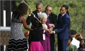  ?? MANUEL BALCE CENETA — THE ASSOCIATED PRESS ?? President Barack Obama, with first lady Michelle Obama and Ruth Odom Bonner, center, ring the bell opening the Smithsonia­n National Museum of African American History and Culture on the National Mall in Washington, Saturday.