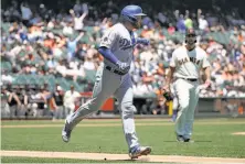  ?? Jeff Chiu / Associated Press ?? The Dodgers’ Max Muncy gets into it with the Giants’ Madison Bumgarner as Muncy starts his home-run trot in the first.