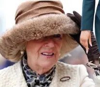 ??  ?? Keeping a tight grip: Camilla in fur-brimmed hat