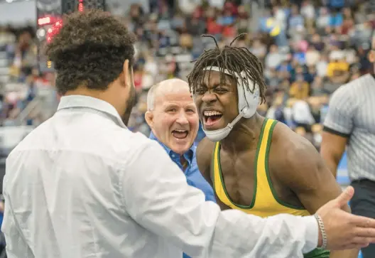  ?? MIKE CAUDILL/FREELANCE PHOTOS ?? Great Bridge’s Aaron Turner, right, celebrates with coaches Steve Martin, center, and Kevin Johnson after defeating Dominion’s Santiago Pena in the 157-pound VHSL Class 4 final at the Virginia Beach Sports Center on Saturday.