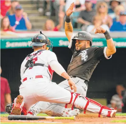  ??  ?? Indians catcher Yan Gomes tags out Melky Cabrera at the plate in the second inning Saturday at Progressiv­e Field. | GETTY IMAGES