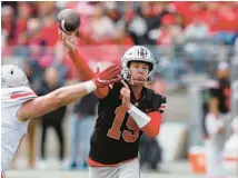  ?? JAY LAPRETE/AP ?? Ohio State quarterbac­k Devin Brown throws a pass during the spring game in 2022.