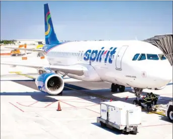  ?? MORIS MORENO/THE NEW YORK TIMES ?? A Spirit Airlines plane sits on the tarmac at Fort Lauderdale-Hollywood Internatio­nal Airport in Florida, in 2013. Major airlines like American and United have announced that they have begun selling basic economy fares comparable to those offered by...