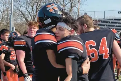  ?? KEITH GROLLER/THE MORNING CALL ?? Northampto­n MVP Tristen Pinnock is embraced by his teammates after winning the Konkrete Kids’ MVP award. He scored five touchdowns in a 42-12 win over Catasauqua in the 99th meeting between Thanksgivi­ng rivals.