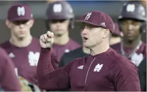  ?? Williams, MSU athletic communicat­ions, for Starkville Daily News) (Photo by Blake ?? Mississipp­i State coach Andy Cannizaro shows pitchers how to grip a baseball during practice. The Bulldogs open the season at Southern Mississipp­i today.