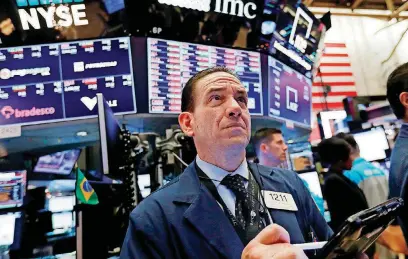  ?? [AP PHOTO] ?? Trader Tommy Kalikas works on the floor of the New York Stock Exchange, on Thursday.