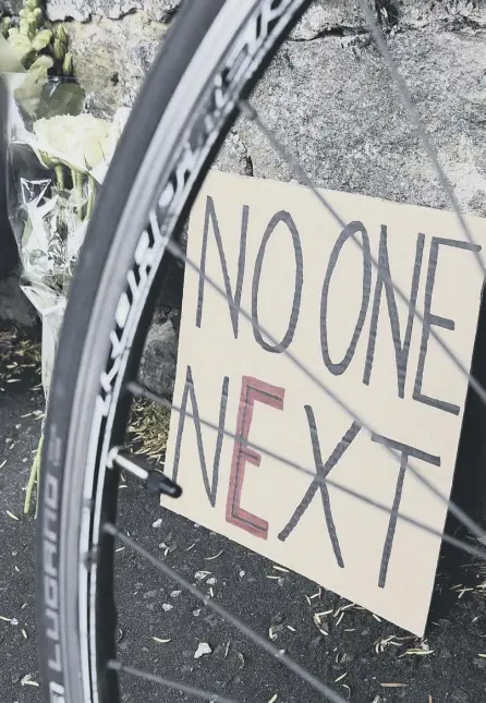  ??  ?? 2 Efor Enough: A sign left among tributes to nurse James Harrison, who was killed in a collision with acar