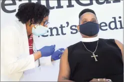  ?? Ned Gerard / Hearst Connecticu­t Media ?? Nurse Marie St. Jean administer­s a COVID-19 vaccinatio­n to the Rev. Brenda Barnes, of Faith Gospel Assembly Church.