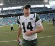  ?? LYNNE SLADKY - THE ASSOCIATED PRESS ?? FILE - In this Sunday, Nov. 4, 2018, file photo, New York Jets quarterbac­k Sam Darnold (14) walks off the field after an NFL football game in Miami Gardens, Fla. Darnold has a boot on his right foot and is not practicing, leaving his status for the team’s game against Buffalo on Sunday in doubt. Darnold was injured during the Jets’ 13-6 loss at Miami last Sunday, but finished the game.