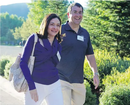  ?? — THE ASSOCIATED PRESS FILES ?? Facebook COO Sheryl Sandberg, left, and her husband, David Goldberg, are pictured in 2011. Goldberg died suddenly when the two were vacationin­g in Mexico in May 2015.