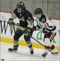  ??  ?? Stoney Creek’s Andrew Garlick (9) and Birmingham Unified’s Lukas Robinson (13) battle for the puck during the OAA matchup played on Monday, February 15, 2021at the Birmingham Ice Arena. Garlick had two goals for the Cougars, but they lost the game 9-6.