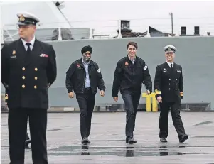  ?? CP PHOTO ?? Prime Minister Justin Trudeau, Minister of National Defence Harjit Sajjan and Rear Admiral Art McDonald walk up to speak to media after meeting with members of the Canadian Forces at CFB Esquimalt in Esquimalt, B.C., on Thursday, March 2. Wile the...