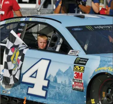  ?? PAUL SANCYA — THE ASSOCIATED PRESS ?? Kevin Harvick’s son, Keelan, rides into Winner’s Circle with his father after a NASCAR Cup Series auto race at Michigan Internatio­nal Speedway in Brooklyn, Mich., Sunday.