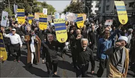  ?? VAHID SALEMI / ASSOCIATED PRESS ?? Iranians march in Tehran on Friday during an anti-U.S. rally to condemn remarks made by President Donald Trump on Tuesday at the United Nations.