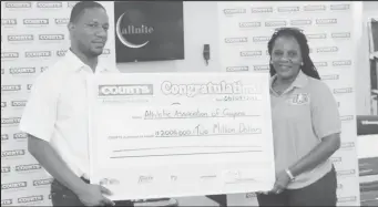  ??  ?? AAG’s Mayfield Taylor-Trim (right) is all smiles as receives the sponsorshi­p cheque from Courts (Unicomer Guyana Inc.) Marketing Manager, Pernell Cummings.