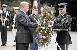  ?? EVAN VUCCI/AP ?? President Donald Trump lays a wreath Monday during a Memorial Day ceremony at Arlington National Cemetery.