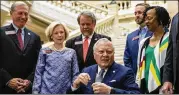  ?? ALYSSA POINTER/ALYSSA.POINTER@AJC.COM ?? In recent AJC polling, Gov. Nathan Deal (center) was easily the state’s most-liked politician. Nearly half of Democrats approved of his performanc­e, while 85 percent of Republican­s said he was doing a good job.