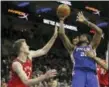  ?? RICH SCHULTZ — THE ASSOCIATED PRESS ?? Philadelph­ia 76ers center Joel Embiid (21) attempts a shot as Toronto Raptors center Jakob Poeltl (42) defends during the fourth quarter in Philadelph­ia, Monday.