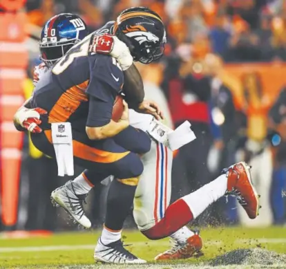  ?? Helen H. Richardson, The Denver Post ?? Jason Pierre-Paul of the New York Giants sacks Broncos quarterbac­k Trevor Siemian during the fourth quarter Sunday night at Sports Authority Field at Mile High.