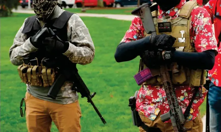  ?? Photograph: Jeff Kowalsky/AFP/Getty Images ?? Armed protesters at an ‘American Patriot Rally,’ on the steps of the Michigan state capitol in Lansing, 30 April 2020. MyMilitia had at least 20,000 users as of early October.