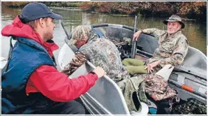  ??  ?? On the hunt: David Klee, left, talks to Don Kerr and Keith Sharp before they set out on a hunting trip.