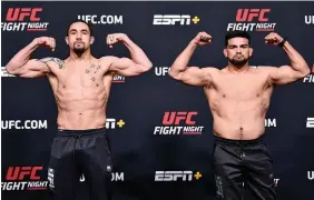  ?? Photo / Getty Images ?? Opponents Robert Whittaker (left) and Kelvin Gastelum pose at the UFC weigh-in in Las Vegas yesterday.