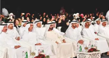  ??  ?? Top: Shaikh Mohammad follows proceeding­s with Shaikh Hamdan, Shaikh Saif, Shaikh Ahmad, Shaikh Hasher, other shaikhs and senior officials. The musical show included six acts, which reflected the advanced cultural scene, and the UAE’s national...