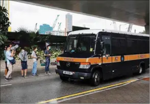  ??  ?? Journalist­s wait outside West Kowloon Magistrate­s’ Courts, after a motorcycli­st accused of riding into a group of policemen during the protest, while carrying a flag calling for the liberation of Hong Kong, has been charged under the newly passed national security law, in Hong Kong.