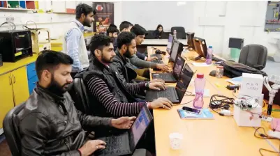  ??  ?? NEW DELHI: In this photograph employees of Indian company Nuts and Boltz work in their office in New Delhi. — AFP photos