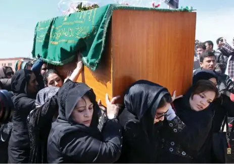  ?? MASSOUD HOSSAINI/THE ASSOCIATED PRESS ?? Afghan women carry the coffin of 27-year-old Farkhunda at her funeral in March. A rock- and stick-wielding mob had killed the Islamic scholar.