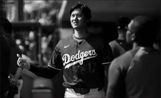  ?? ASHLEY LANDIS / ASSOCIATED PRESS ?? Los Angeles Dodgers star Shohei Ohtani, seen Tuesday in the dugout during a spring training game in Phoenix, will be limited largely to being a designated hitter this season after undergoing elbow surgery last year.